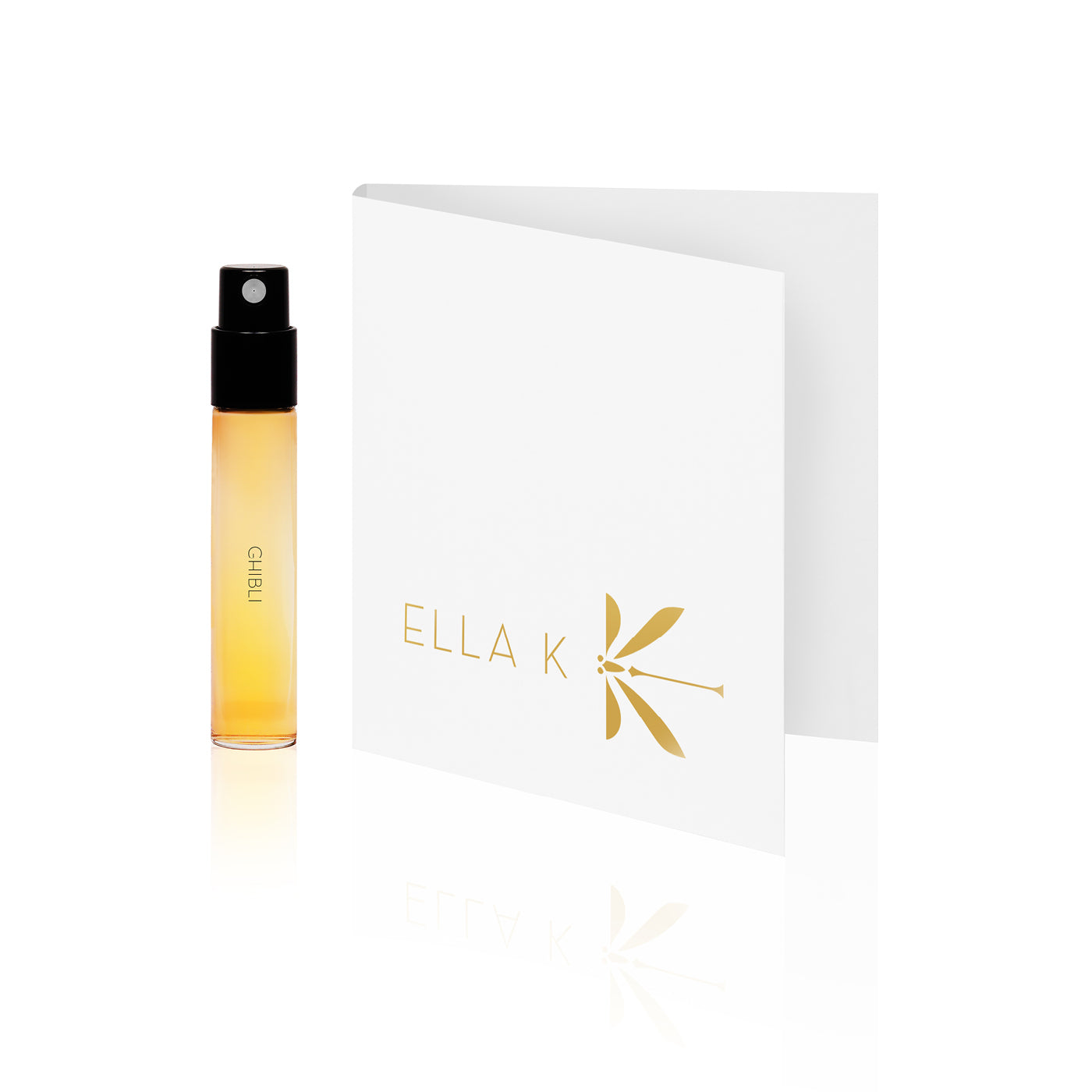 Flacon d’échantillon du parfum Ghibli d’Ella K, placé à côté d’une carte pliée blanche élégante avec le logo doré d’Ella K, sur fond blanc.